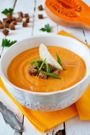 puree soup of celery and pumpkin with rye croutonsの写真素材