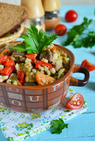 Vegetable stew with meat and barley on a blue backgroundの写真素材