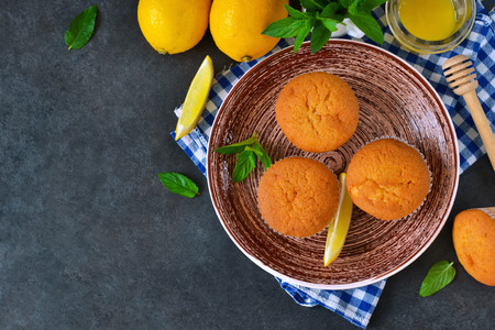 Homemade, lemon muffins with honey and mint on a concrete backgroundの写真素材