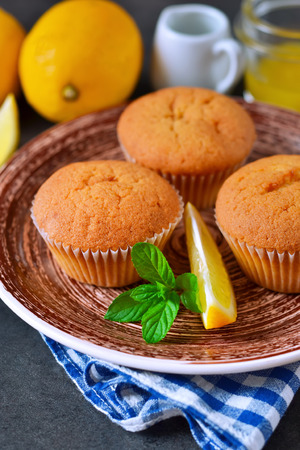 Homemade, lemon muffins with honey and mint on a concrete backgroundの写真素材