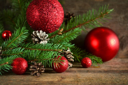 Happy New Year - a holiday background with fir, balls, cones on the wooden backgroundの写真素材
