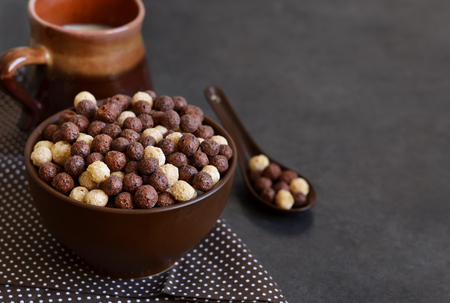 Healthy breakfast. Chocolate breakfast cereal with milk on a black background.の写真素材