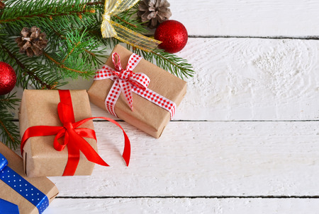 Happy New Year - Christmas background with gift boxes under the fir with cones and balls on a white backgroundの写真素材