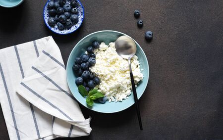 Beautiful breakfast - cottage cheese, berries and honey on the kitchen table. Good morning.の写真素材
