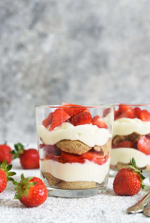 Strawberry tiramisu in a glass on a concrete background. Classic Italian dessert.の写真素材