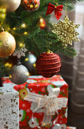 Christmas decoration. Christmas fir with balls of boxes with gifts in the room.の写真素材