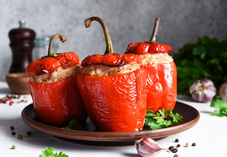 The traditional dish is stuffed peppers with pork and rice on a light concrete background.の写真素材