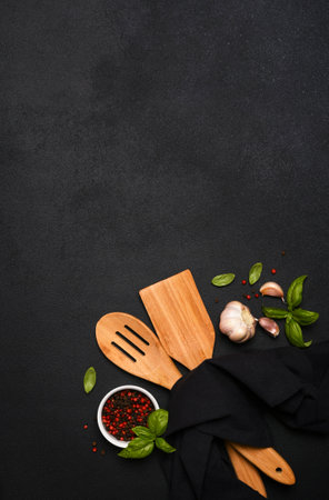 Black Food with kitchen utensils. Kitchen towe andl spatula on a black background.の写真素材