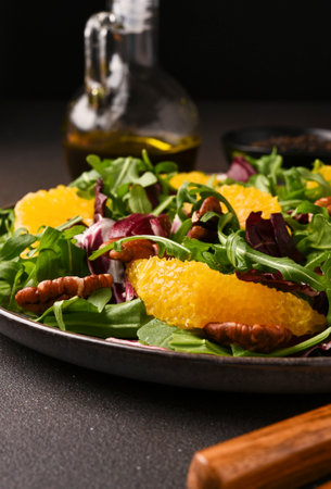 Arugula, orange and pecan salad. Radicchio salad on brown backgroundの写真素材