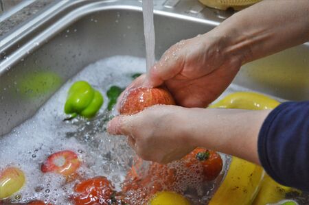 wash fruit in clean water - appleの写真素材