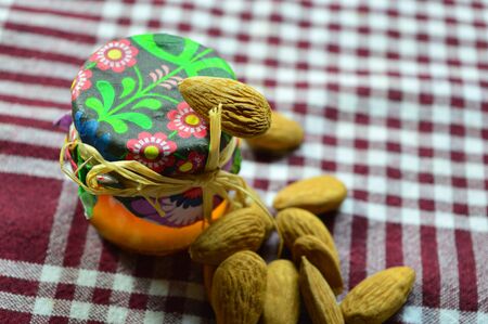 jar honey and almonds on the checkered fabricの写真素材