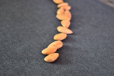 almonds on the black backgroundの写真素材