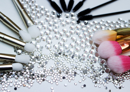 Makeup brushes and Swarovski stones, makeup shades.