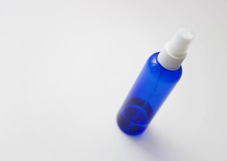 A bottle for spraying water, a blue liquid containerの写真素材
