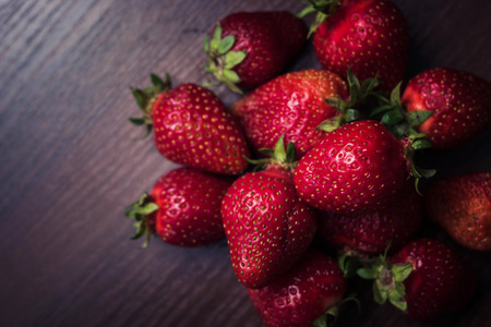 Strawberry with leaves on a brown treeの写真素材