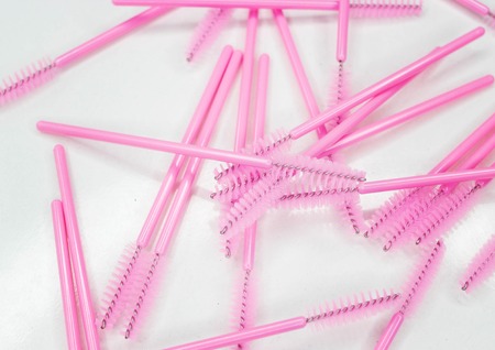 Many scattered eyeliner brushes on a white backgroundの写真素材