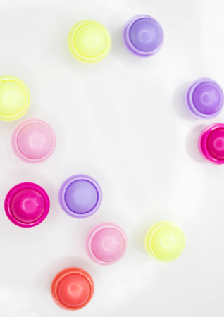 Multicolored balsams for lips on a white background of different taste
