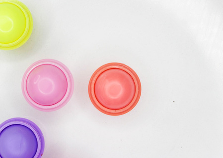 Multicolored balsams for lips on a white background of different tasteの写真素材