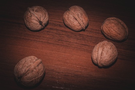 Walnuts. Nuts on a dark wooden background. Very useful fruits for the brain.