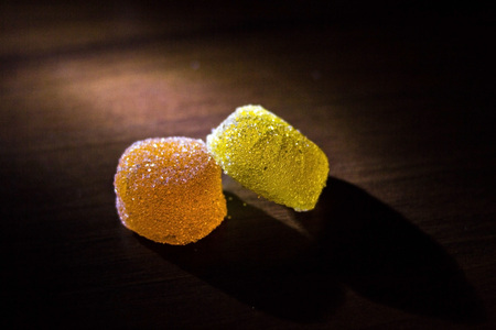 Multicolored marmalade in sugar on a dark background.の写真素材