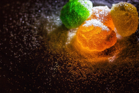 Multicolored marmalade in sugar on a dark background.の写真素材