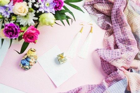 Sticker on pink near flowers and women's cosmetics accessories and jewelryの写真素材