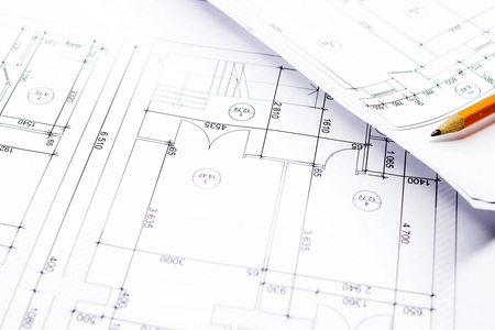 Close-up with a pencil above drawings with sketches of projects.