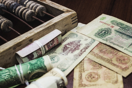 Ancient money of different denominations on a tree near accounts