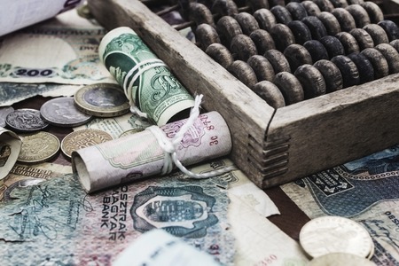 Ancient money of different denominations on a tree near accounts
