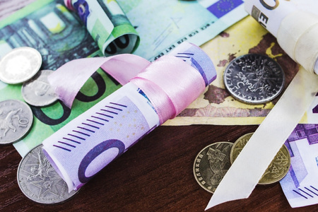 Euros of different denominations twisted into a tube