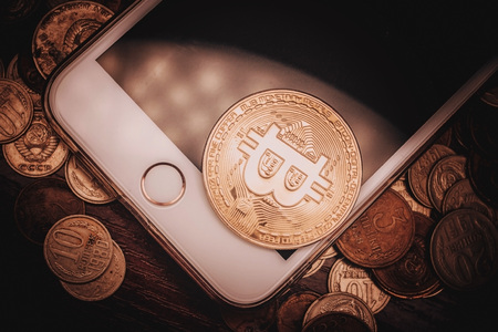 New currency bitcoin on a cell phone and old coins of the USSRの写真素材