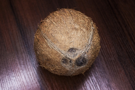 Ripe half cut coconut on a wooden background. Ripe half cut coconut on a wooden background. Coconut cream and oil.の写真素材