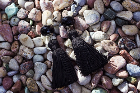 Earrings-brushes lying on sea stones of different colors. Earrings handmade. Sergi of silk thread and silver.の写真素材