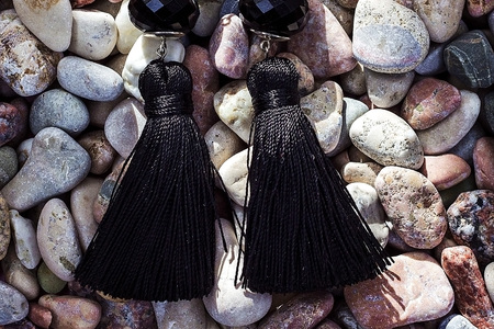 Earrings-brushes lying on sea stones of different colors. Earrings handmade. Sergi of silk thread and silver.の写真素材