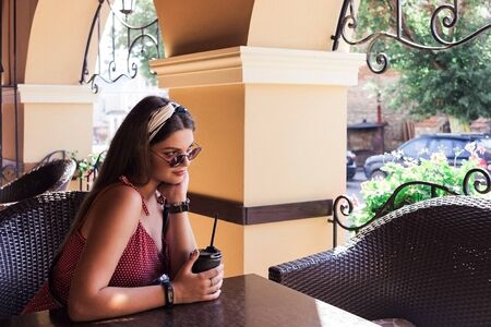 Kamenetz-Podolsk. UKRAINE. August 16 2018 Girl with coffeeのeditorial素材
