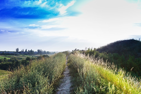 Trail on the mountain at sunsetの写真素材