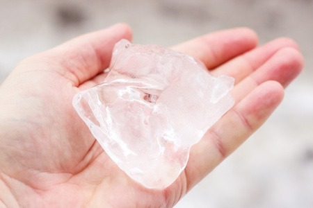Ice crystal of water on the palm of a personの写真素材