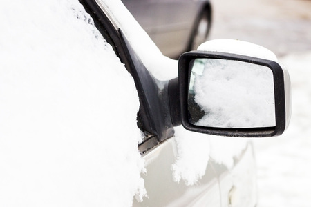 Car on the street covered by icy rainの写真素材