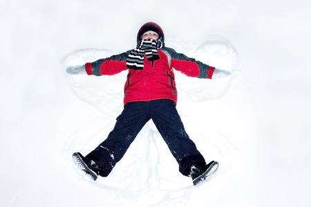 Angel in the winter on white snowの写真素材