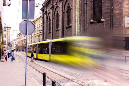 Lviv, Ukraine - July 16, 2019: Lviv. UKRAINE July 16 2019 Yellow tram with motion blur effect moves...