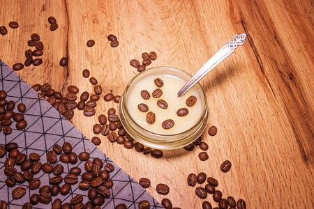 Breakfast scene. Honey pouring from glass jarの写真素材