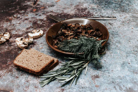Mushrooms on a plate with herbsの写真素材