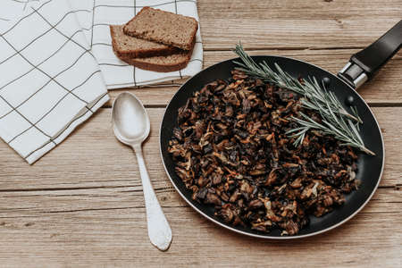 Fried mushrooms in a pan. Fried mushroom in frying pan is isolatedの写真素材
