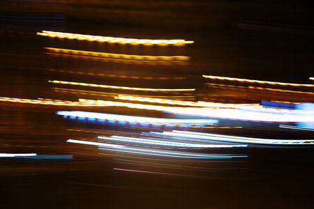 Night lights in blur. Blurred Defocused Lights of Heavy Traffic on a Wet Rainy