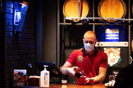Kiev UKRAINE. August 13 2021. Sommelier pours wine from a barrel