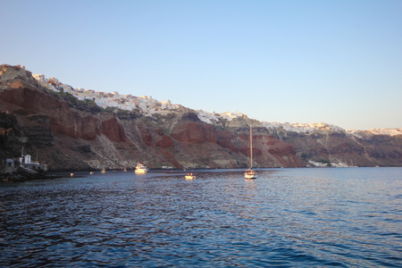 The bay at the foot of the city of Oia in Santorini.の写真素材