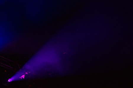 Glow of purple and fizzy light towards the night sky.の写真素材