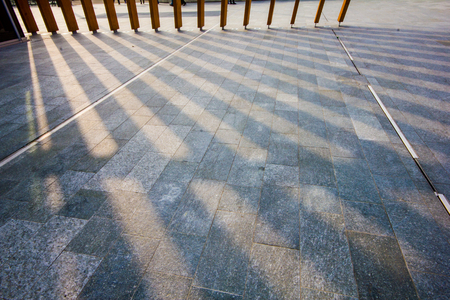 The shadows of a modern structure are projected onto the floor of the square. Milan 02/22/2018の写真素材