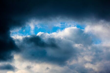Winter blue sky with clouds over the horizon.