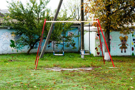Children's swing on the playground near the building